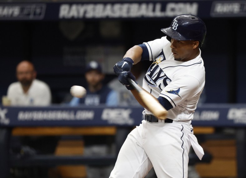 Apr 9, 2022; St. Petersburg, Florida, USA; Tampa Bay Rays catcher Francisco Mejia (21) hits a RBI single during the second inning against the Baltimore Orioles  at Tropicana Field. Mandatory Credit: Kim Klement-USA TODAY Sports