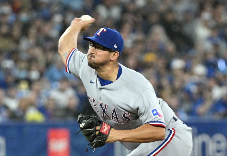 Apr 9, 2022; Toronto, Ontario, CAN;   Texas Rangers starting pitcher Dane Dunning (33) delivers a pitch against the Toronto Blue Jays in the first inning at Rogers Centre. Mandatory Credit: Dan Hamilton-USA TODAY Sports