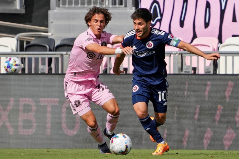 Apr 9, 2022; Fort Lauderdale, Florida, USA; New England Revolution midfielder Carles Gil (10) controls the ball while defended by Inter Miami CF defender Noah Allen (32) during the second half at DRV PNK Stadium. Mandatory Credit: Jasen Vinlove-USA TODAY Sports