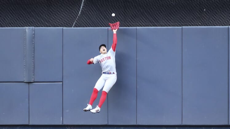 Apr 9, 2022; Bronx, New York, USA;  Boston Red Sox center fielder Enrique Hernandez (5) makes a leaping catch in the fourth inning against the New York Yankees at Yankee Stadium. Mandatory Credit: Wendell Cruz-USA TODAY Sports