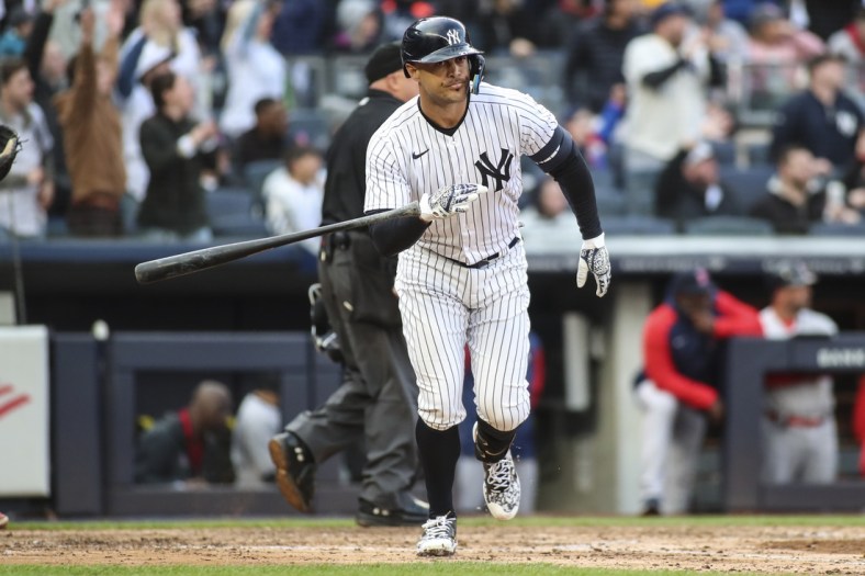 Apr 9, 2022; Bronx, New York, USA;  New York Yankees designated hitter Giancarlo Stanton (27) flips his bat after hitting a two run home run in the sixth inning against the Boston Red Sox at Yankee Stadium. Mandatory Credit: Wendell Cruz-USA TODAY Sports