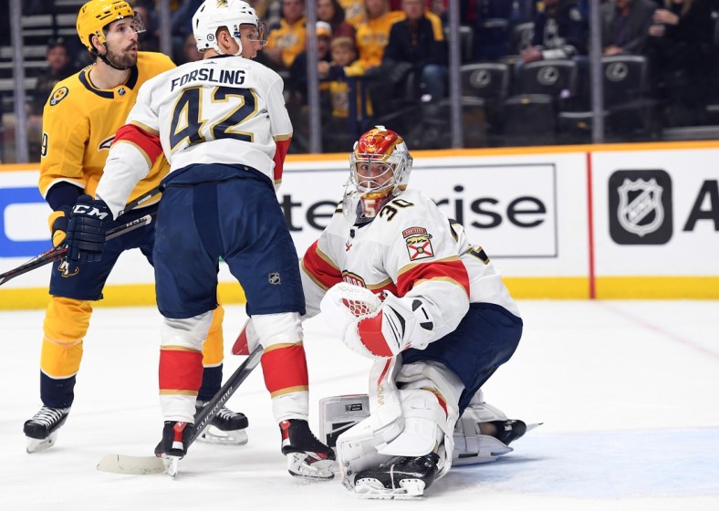 Apr 9, 2022; Nashville, Tennessee, USA; Florida Panthers goaltender Spencer Knight (30) watches as the puck goes wide of the net during the first period against the Nashville Predators at Bridgestone Arena. Mandatory Credit: Christopher Hanewinckel-USA TODAY Sports