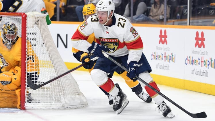 Apr 9, 2022; Nashville, Tennessee, USA; Florida Panthers center Carter Verhaeghe (23) handles the puck behind the Nashville Predators net during the second period at Bridgestone Arena. Mandatory Credit: Christopher Hanewinckel-USA TODAY Sports