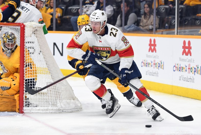 Apr 9, 2022; Nashville, Tennessee, USA; Florida Panthers center Carter Verhaeghe (23) handles the puck behind the Nashville Predators net during the second period at Bridgestone Arena. Mandatory Credit: Christopher Hanewinckel-USA TODAY Sports