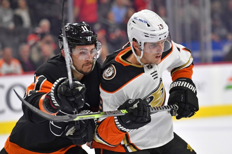 Apr 9, 2022; Philadelphia, Pennsylvania, USA; Philadelphia Flyers right wing Travis Konecny (11) and Anaheim Ducks right wing Troy Terry (19) battle during the first period at Wells Fargo Center. Mandatory Credit: Eric Hartline-USA TODAY Sports