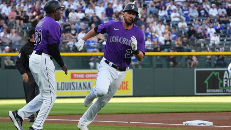 Apr 9, 2022; Denver, Colorado, USA;  Colorado Rockies left fielder Kris Bryant (23) runs past third base coach Stu Cole (39) to score a run in the first inning against the Los Angeles Dodgers at Coors Field. Mandatory Credit: Ron Chenoy-USA TODAY Sports