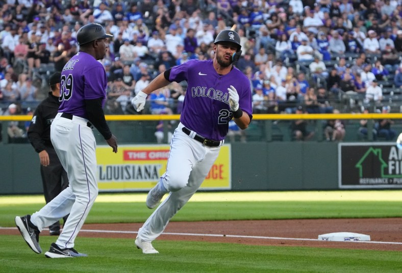 Apr 9, 2022; Denver, Colorado, USA;  Colorado Rockies left fielder Kris Bryant (23) runs past third base coach Stu Cole (39) to score a run in the first inning against the Los Angeles Dodgers at Coors Field. Mandatory Credit: Ron Chenoy-USA TODAY Sports