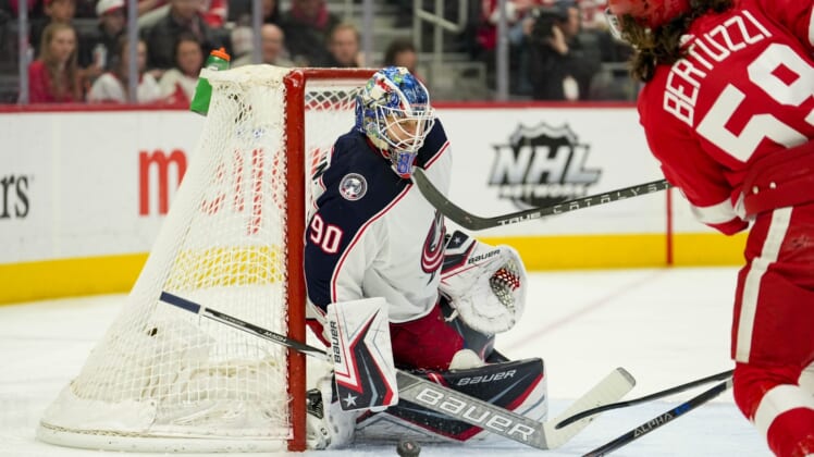 Apr 9, 2022; Detroit, Michigan, USA; Columbus Blue Jackets goaltender Elvis Merzlikins (90) makes a save against Detroit Red Wings left wing Tyler Bertuzzi (59) during the second period at Little Caesars Arena. Mandatory Credit: Raj Mehta-USA TODAY Sports