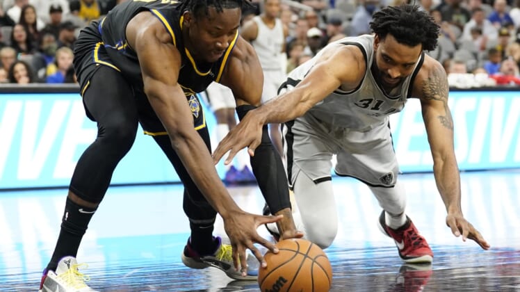 Apr 9, 2022; San Antonio, Texas, USA; Golden State Warriors forward Jonathan Kuminga (left) and San Antonio Spurs forward Keita Bates-Diop (right) battle for a loose ball during the first half at AT&T Center. Mandatory Credit: Scott Wachter-USA TODAY Sports