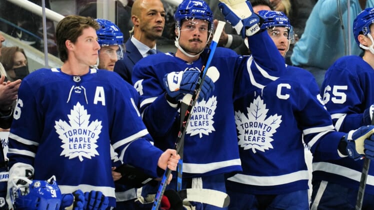 Apr 9, 2022; Toronto, Ontario, CAN; Toronto Maple Leafs forward Auston Matthews (middle) acknowledges a tribute by fans after setting a new Maple Leafs single season record for goals during a break in the action against the Montreal Canadiens at Scotiabank Arena. Mandatory Credit: John E. Sokolowski-USA TODAY Sports
