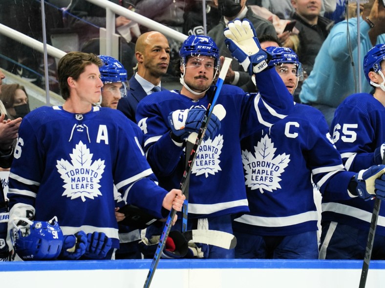 Apr 9, 2022; Toronto, Ontario, CAN; Toronto Maple Leafs forward Auston Matthews (middle) acknowledges a tribute by fans after setting a new Maple Leafs single season record for goals during a break in the action against the Montreal Canadiens at Scotiabank Arena. Mandatory Credit: John E. Sokolowski-USA TODAY Sports