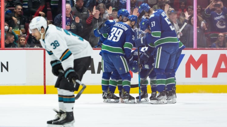 Apr 9, 2022; Vancouver, British Columbia, CAN;  Vancouver Canucks right wing Conor Garland (8) is congratulated after scoring a goal as San Jose Sharks defenseman Mario Ferraro (38) skates on in the second period at Rogers Arena. Mandatory Credit: Derek Cain-USA TODAY Sports