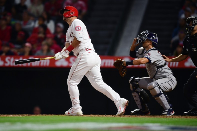 Apr 9, 2022; Anaheim, California, USA; Los Angeles Angels center fielder Mike Trout (27) hits a solo home run against the Houston Astros during the eighth inning at Angel Stadium. Mandatory Credit: Gary A. Vasquez-USA TODAY Sports