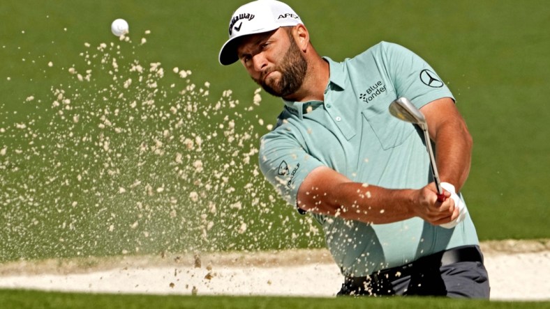 Apr 10, 2022; Augusta, Georgia, USA; Jon Rahm plays a shot from a bunker on the second hole during the final round of the Masters golf tournament. Mandatory Credit: Rob Schumacher-USA TODAY Sports