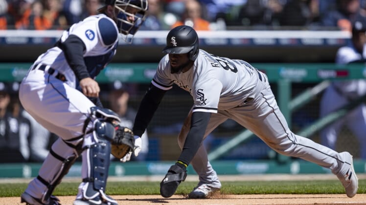 Apr 10, 2022; Detroit, Michigan, USA; Chicago White Sox center fielder Luis Robert (88) slides safe into home plate against Detroit Tigers catcher Tucker Barnhart (15) during the first inning at Comerica Park. Mandatory Credit: Raj Mehta-USA TODAY Sports