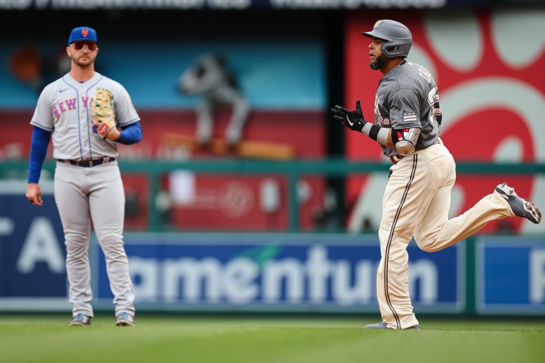 Apr 10, 2022; Washington, District of Columbia, USA; Washington Nationals designated hitter Nelson Cruz (23) rounds the bases in front of New York Mets first baseman Pete Alonso (20) after hitting a home run during the first inning at Nationals Park. Mandatory Credit: Scott Taetsch-USA TODAY Sports