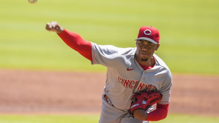 Apr 10, 2022; Cumberland, Georgia, USA; Cincinnati Reds starting pitcher Hunter Greene (21) pitches against the Atlanta Braves during the first inning at Truist Park. Mandatory Credit: Dale Zanine-USA TODAY Sports