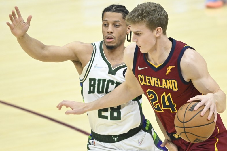 Apr 10, 2022; Cleveland, Ohio, USA; Cleveland Cavaliers forward Lauri Markkanen (24) drives against Milwaukee Bucks guard Lindell Wigginton (28) in the first quarter at Rocket Mortgage FieldHouse. Mandatory Credit: David Richard-USA TODAY Sports