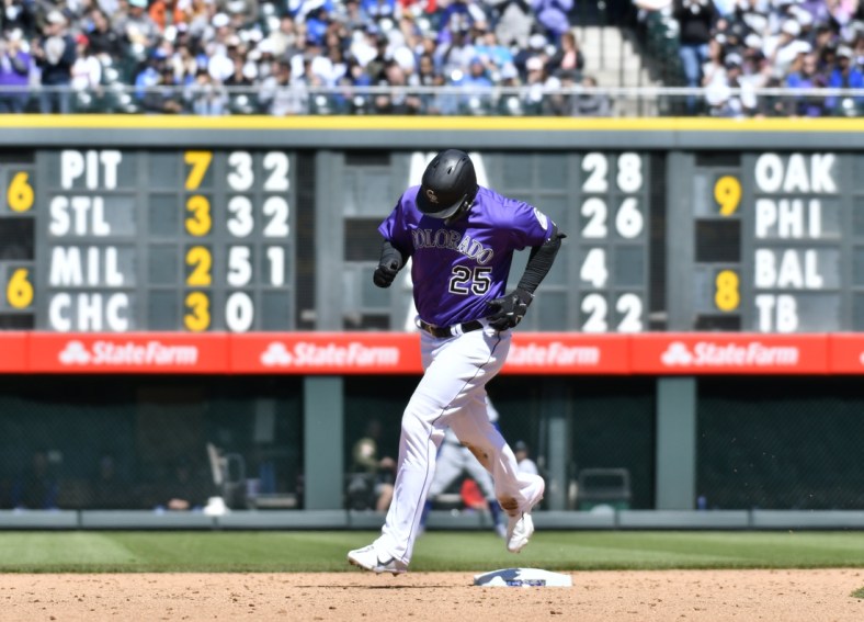 Apr 10, 2022; Denver, Colorado, USA; Colorado Rockies first baseman C.J. Cron (25) rounds second base after hitting a two-run home run in the third inning against the Los Angeles Dodgers at Coors Field. Mandatory Credit: John Leyba-USA TODAY Sports