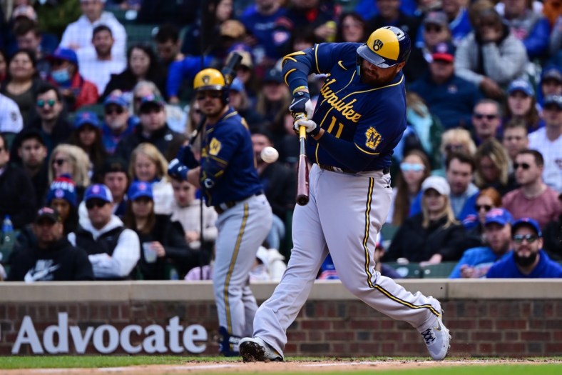 Apr 10, 2022; Chicago, Illinois, USA; Milwaukee Brewers first baseman Rowdy Tellez (11) hits a two run home run in the sixth inning against the Chicago Cubs at Wrigley Field. Mandatory Credit: Quinn Harris-USA TODAY Sports