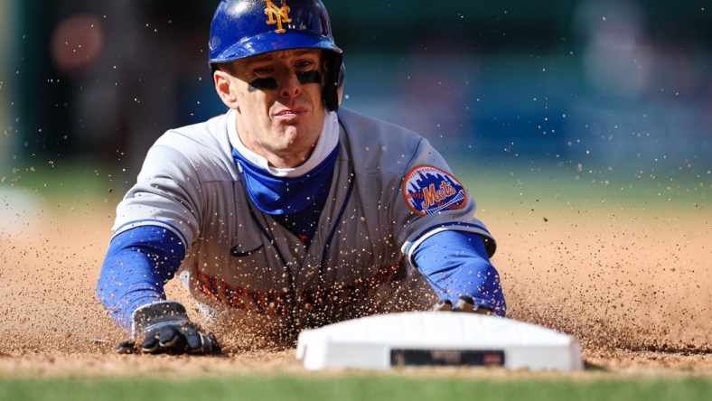 Apr 10, 2022; Washington, District of Columbia, USA; New York Mets right fielder Mark Canha (19) slides into first base against the Washington Nationals during the ninth inning at Nationals Park. Mandatory Credit: Scott Taetsch-USA TODAY Sports