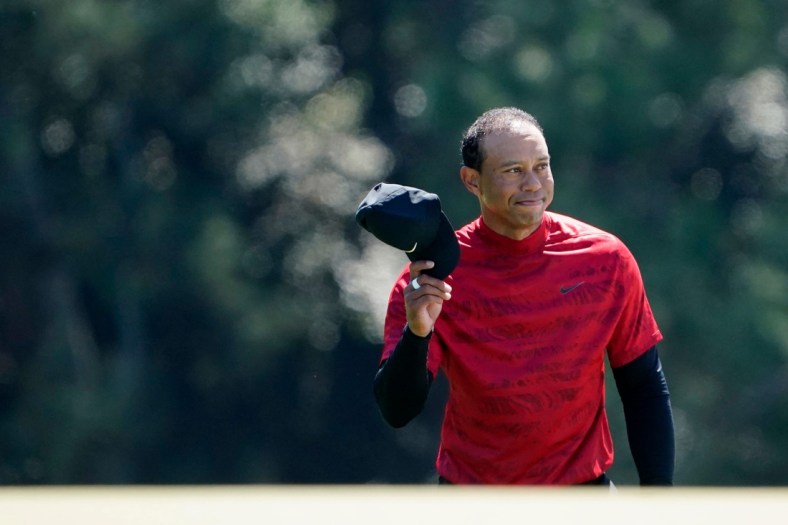Tiger Woods tips his hat to the fans as they applaud as he walks up No. 18 during the final round of the Masters at Augusta National Golf Club.

2022-4-10-tiger-woods-cap