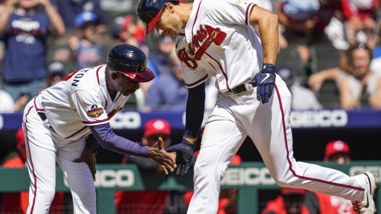 Apr 10, 2022; Cumberland, Georgia, USA; Atlanta Braves first baseman Matt Olson (28) (right) reacts with third base coach Ron Washington (37) after hitting a home run against the Cincinnati Reds during the fifth inning at Truist Park. Mandatory Credit: Dale Zanine-USA TODAY Sports