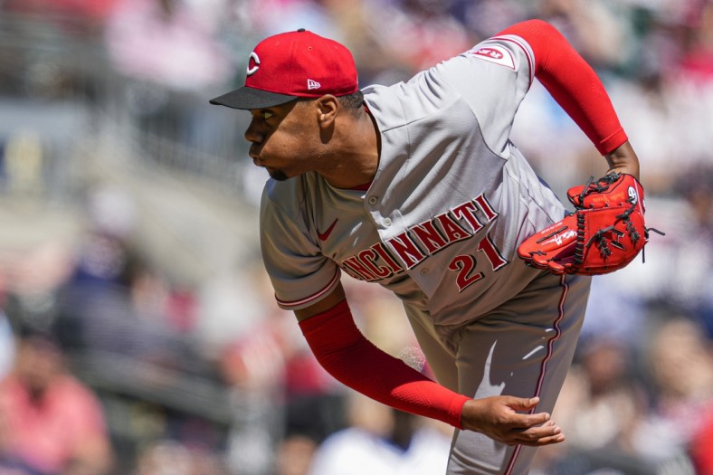Apr 10, 2022; Cumberland, Georgia, USA; Cincinnati Reds starting pitcher Hunter Greene (21) pitches against the Atlanta Braves during the fourth inning at Truist Park. Mandatory Credit: Dale Zanine-USA TODAY Sports