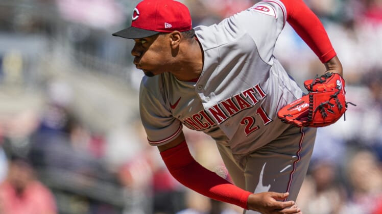 Apr 10, 2022; Cumberland, Georgia, USA; Cincinnati Reds starting pitcher Hunter Greene (21) pitches against the Atlanta Braves during the fourth inning at Truist Park. Mandatory Credit: Dale Zanine-USA TODAY Sports