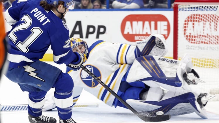 Apr 10, 2022; Tampa, Florida, USA;Tampa Bay Lightning center Brayden Point (21) shoots on goal as Buffalo Sabres goaltender Craig Anderson (41) makes a save  during the first period at Amalie Arena. Mandatory Credit: Kim Klement-USA TODAY Sports