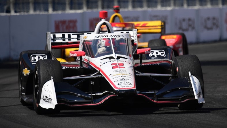 Apr 10, 2022; Long Beach, California, USA; Team Penske driver Josef Newgarden (2) of United States leads Andretti Autosport driver Romain Grosjean (28) of France during the Grand Prix of Long Beach at Long Beach Street Circuit. Mandatory Credit: Gary A. Vasquez-USA TODAY Sports