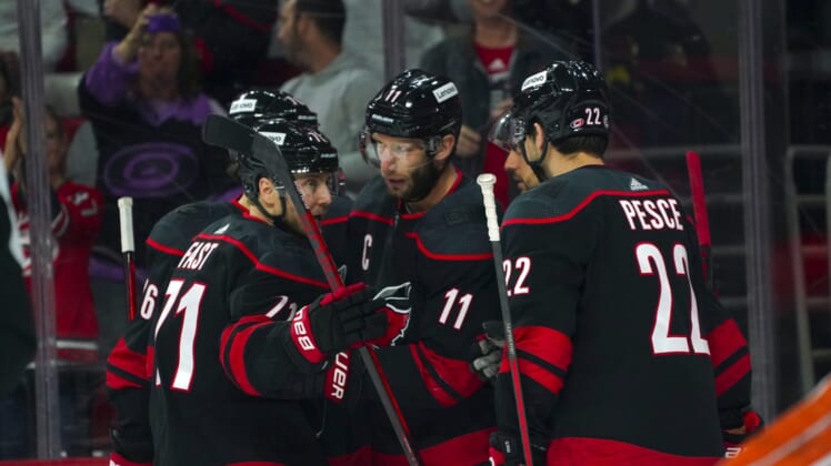 Apr 10, 2022; Raleigh, North Carolina, USA;  Carolina Hurricanes center Jordan Staal (11) is congratulated by  defenseman Brett Pesce (22) and right wing Jesper Fast (71) after his goal against the Anaheim Ducks during the first period at PNC Arena. Mandatory Credit: James Guillory-USA TODAY Sports