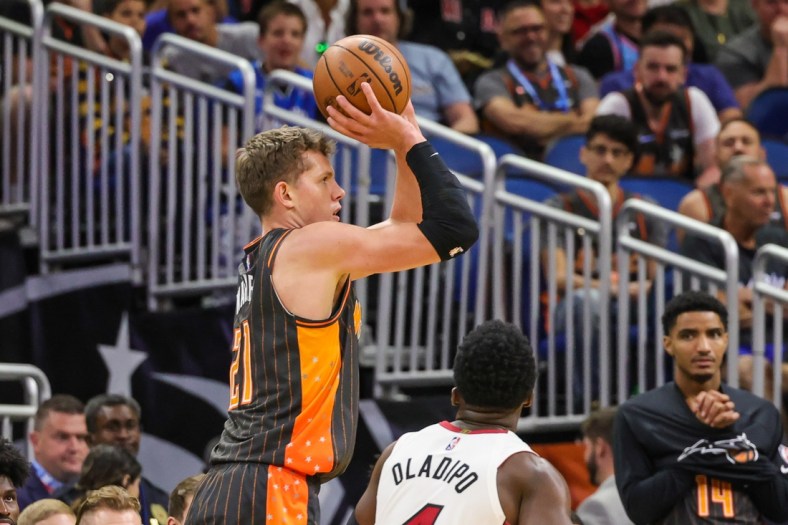 Apr 10, 2022; Orlando, Florida, USA; Orlando Magic center Moritz Wagner (21) shoots the ball against Miami Heat guard Victor Oladipo (4) during the first quarter at Amway Center. Mandatory Credit: Mike Watters-USA TODAY Sports