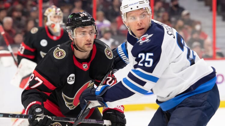 Apr 10, 2022; Ottawa, Ontario, CAN; Ottawa Senators center Dylan Gambrell (27) and Winnipeg Jets center Paul Stastny (25) follow the puck after a face off in the first period at the Canadian Tire Centre. Mandatory Credit: Marc DesRosiers-USA TODAY Sports
