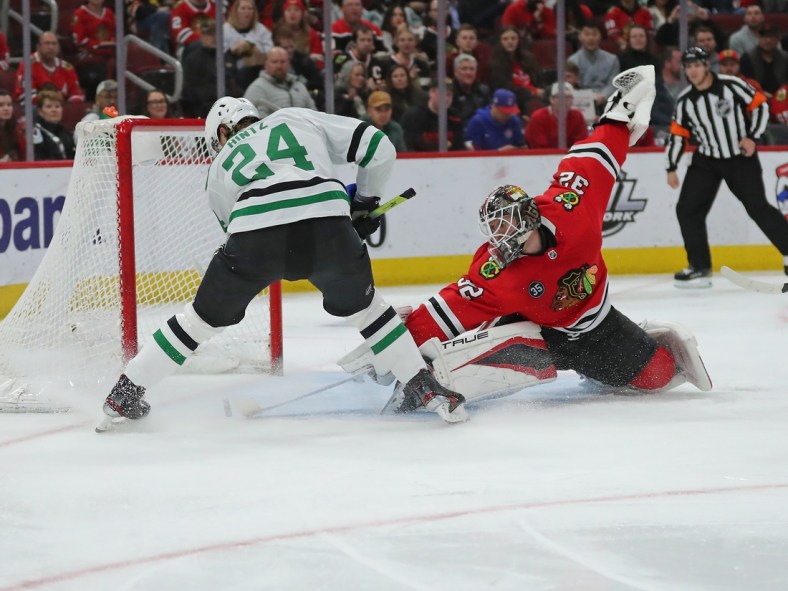 Apr 10, 2022; Chicago, Illinois, USA; Chicago Blackhawks goaltender Kevin Lankinen (32) makes a save on a shot from Dallas Stars center Roope Hintz (24) during the second period at the United Center. Mandatory Credit: Dennis Wierzbicki-USA TODAY Sports