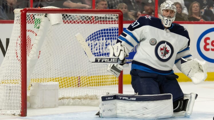 Apr 10, 2022; Ottawa, Ontario, CAN; Winnipeg Jets goalie Connor Hellebuyck (37) makes a save in the second period against the  Ottawa Senators at the Canadian Tire Centre. Mandatory Credit: Marc DesRosiers-USA TODAY Sports