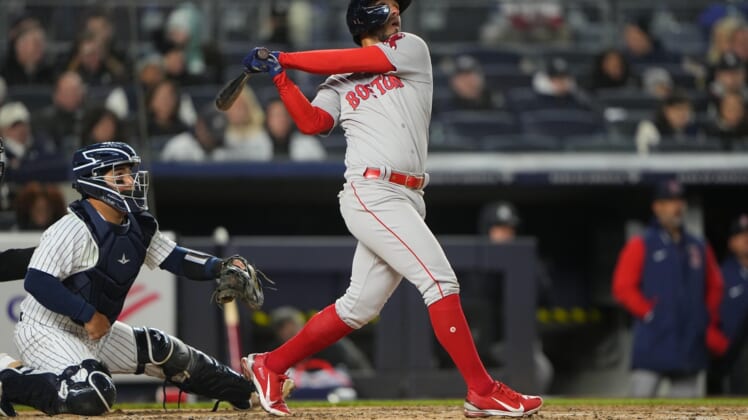 Apr 10, 2022; Bronx, New York, USA; Boston Red Sox second baseman Jonathan Arauz (3) hits a sacrifice fly ball against the New York Yankees during the fourth inning at Yankee Stadium. Mandatory Credit: Gregory Fisher-USA TODAY Sports