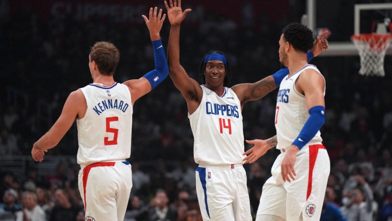 Apr 10, 2022; Los Angeles, California, USA; LA Clippers guard Luke Kennard (5), guard Terance Mann (14) and guard Amir Coffey (7) celebrate in the first half against the Oklahoma City Thunder at Crypto.com Arena. Mandatory Credit: Kirby Lee-USA TODAY Sports