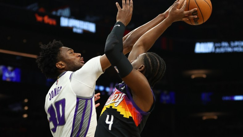 Apr 10, 2022; Phoenix, Arizona, USA; Phoenix Suns guard Aaron Holiday (4) has his shot blocked by Sacramento Kings center Damian Jones (30) during the first half at Footprint Center. Mandatory Credit: Mark J. Rebilas-USA TODAY Sports