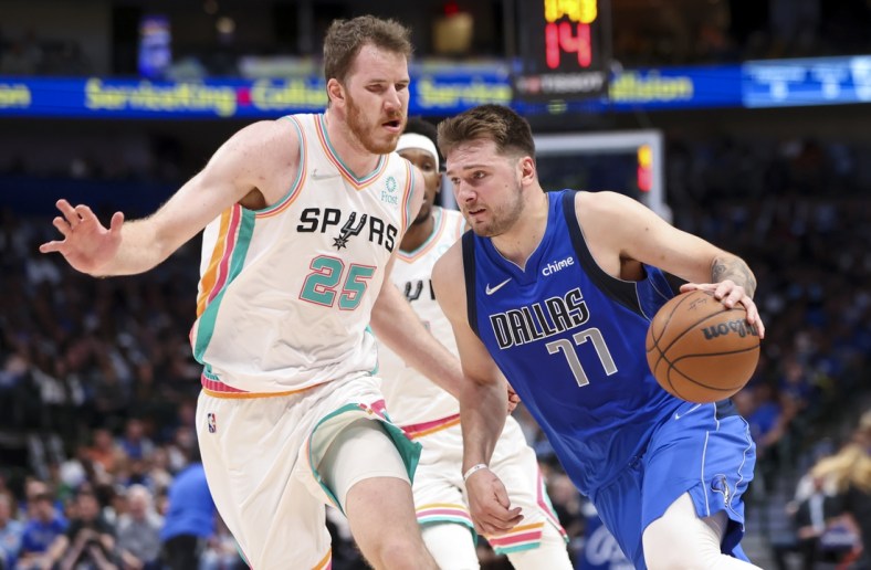 Apr 10, 2022; Dallas, Texas, USA;  Dallas Mavericks guard Luka Doncic (77) drives to the basket past San Antonio Spurs center Jakob Poeltl (25) during the second quarter at American Airlines Center. Mandatory Credit: Kevin Jairaj-USA TODAY Sports