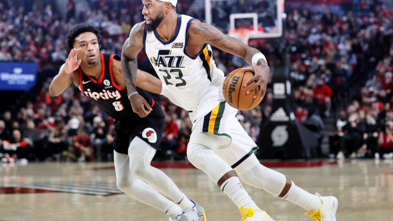 Apr 10, 2022; Portland, Oregon, USA; Utah Jazz power forward Royce O'Neale (23) dribbles the ball while defended by  Portland Trail Blazers point guard Brandon Williams (8) during the first half at Moda Center. Mandatory Credit: Soobum Im-USA TODAY Sports