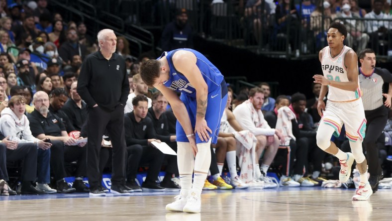 Apr 10, 2022; Dallas, Texas, USA; Dallas Mavericks guard Luka Doncic (77) grabs his left calf during the second half against the San Antonio Spurs at American Airlines Center. Mandatory Credit: Kevin Jairaj-USA TODAY Sports