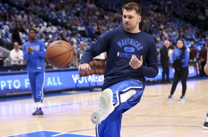 Apr 10, 2022; Dallas, Texas, USA;  Dallas Mavericks guard Luka Doncic (77) kicks the ball while warming up before the game against the San Antonio Spurs at American Airlines Center. Mandatory Credit: Kevin Jairaj-USA TODAY Sports