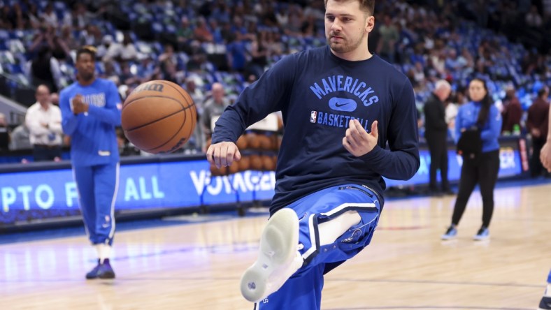 Apr 10, 2022; Dallas, Texas, USA;  Dallas Mavericks guard Luka Doncic (77) kicks the ball while warming up before the game against the San Antonio Spurs at American Airlines Center. Mandatory Credit: Kevin Jairaj-USA TODAY Sports