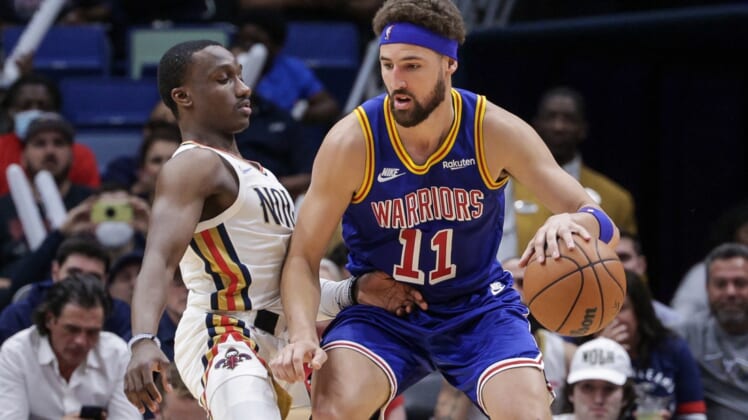 Apr 10, 2022; New Orleans, Louisiana, USA;  Golden State Warriors guard Klay Thompson (11) dribbles against New Orleans Pelicans guard Jared Harper (2) during the second half at the Smoothie King Center. Mandatory Credit: Stephen Lew-USA TODAY Sports