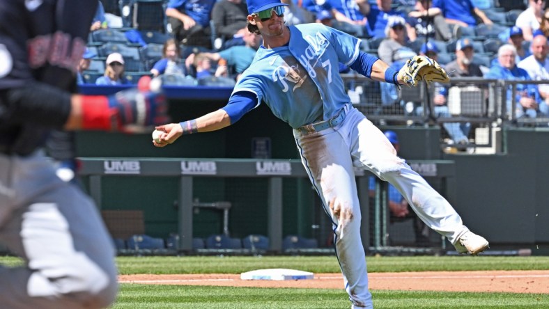 Apr 11, 2022; Kansas City, Missouri, USA;  Kansas City Royals third baseman Bobby Witt Jr. (7) makes a throw to first to throw out Cleveland Guardians base runner Owen Miller (left) during the fourth inning against at Kauffman Stadium. Mandatory Credit: Peter Aiken-USA TODAY Sports