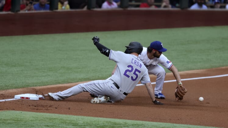 Apr 11, 2022; Arlington, Texas, USA;  Colorado Rockies first baseman C.J. Cron (25) slides safely into third base ahead of the tag by Texas Rangers third baseman Charlie Culberson (11) during the first inning at Globe Life Field. Mandatory Credit: Kevin Jairaj-USA TODAY Sports