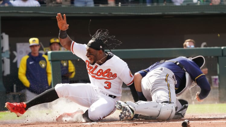 Apr 11, 2022; Baltimore, Maryland, USA; Baltimore Orioles shortstop Jorge Mateo (3) slides home in the second inning past Milwaukee Brewers catcher Victor Caratini (7) following a single by outfielder Cedric Mullins (not shown) at Oriole Park at Camden Yards. Mandatory Credit: Mitch Stringer-USA TODAY Sports