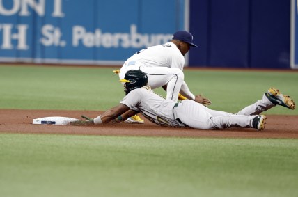 Apr 11, 2022; St. Petersburg, Florida, USA; Oakland Athletics shortstop Elvis Andrus (17) slides into second base after hitting a double ahead of the throw to Tampa Bay Rays shortstop Wander Franco (5) during the first inning at Tropicana Field. Mandatory Credit: Kim Klement-USA TODAY Sports