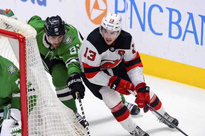Apr 9, 2022; Dallas, Texas, USA; New Jersey Devils center Nico Hischier (13) skates past Dallas Stars center Tyler Seguin (91) during the third period at the at American Airlines Center. Mandatory Credit: Jerome Miron-USA TODAY Sports